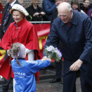 Blomsterbarn og Nils Hætta, leder av Midnight Sun Marathon, tok imot Kongeparet på Stortorget.  Foto: Lise Åserud, NTB scanpix